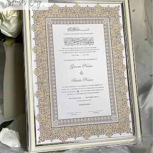 May include: A white framed certificate with gold and black calligraphy. The text reads "This agreement is to certify that the marriage of Groom Name & Bride Name has been solemnised in accordance to the requirements of Islamic Law, as enshrined in the Holy Quran and the Sunnah of Prophet Muhammad... 20th of January 2020 - 25th of Rajab 1441 AH in the city of Paris, France."