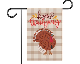 May include: A brown and tan checkered garden flag with the text "happy thanksgiving" in red and orange. A cartoon turkey with a red head and brown feathers is in the bottom right corner.