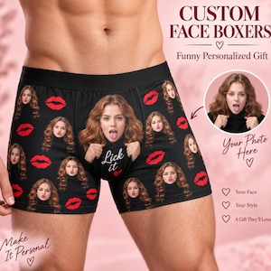 May include: Black boxer briefs featuring a repeating pattern of a woman's face with long wavy hair and red lips. The centre features a larger version of the same face with the text Lick it and a red heart. Text includes CUSTOM FACE BOXERS.