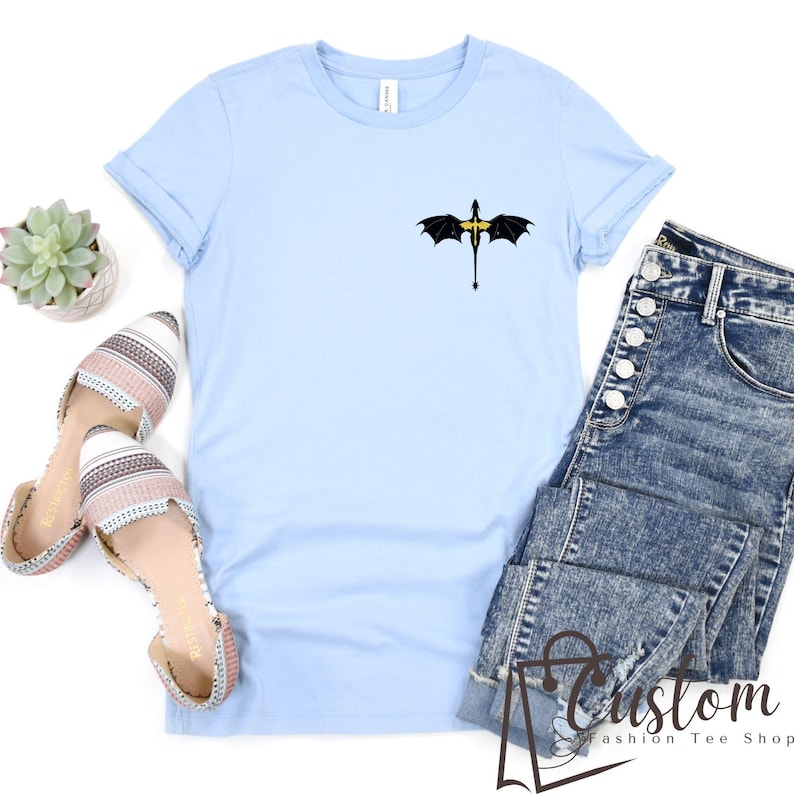 a t - shirt with a bat on it next to a pair of jeans