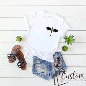 a t - shirt with an umbrella on it next to a pair of shorts