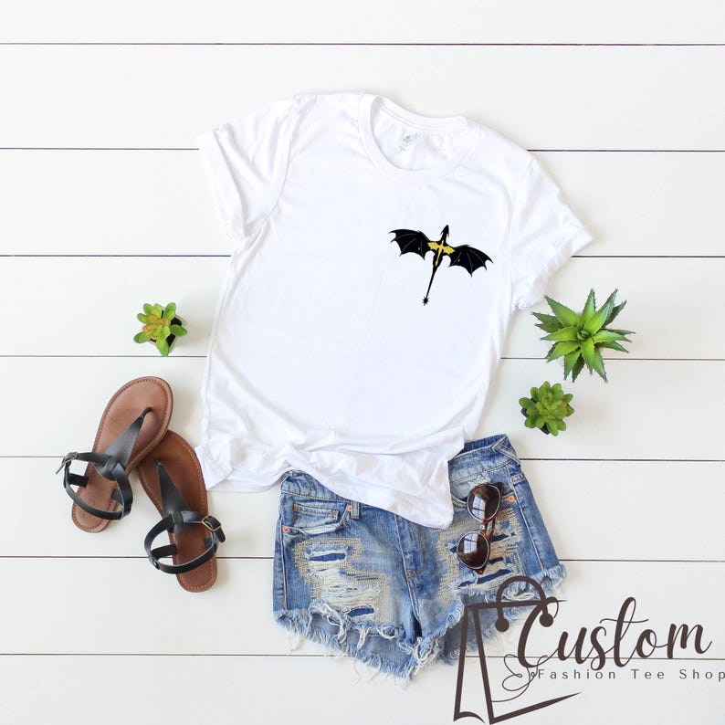 a t - shirt with an umbrella on it next to a pair of shorts