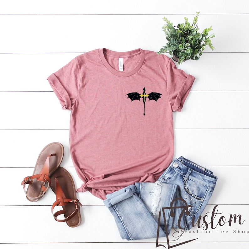 a t - shirt with wings and a cross on it