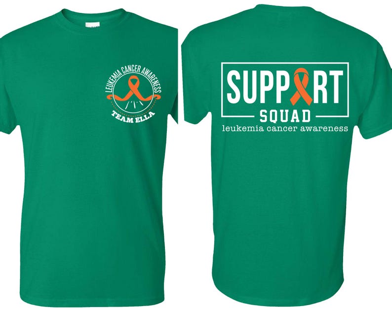 Puede incluir: Una camiseta verde de manga corta con un peque&ntilde;o logotipo circular en el pecho izquierdo que incluye una cinta naranja y el texto "LEUKEMIA CANCER AWARENESS TEAM ELLA". La parte posterior muestra un gran gr&aacute;fico rectangular blanco con "SUPPORT SQUAD" y una cinta naranja.