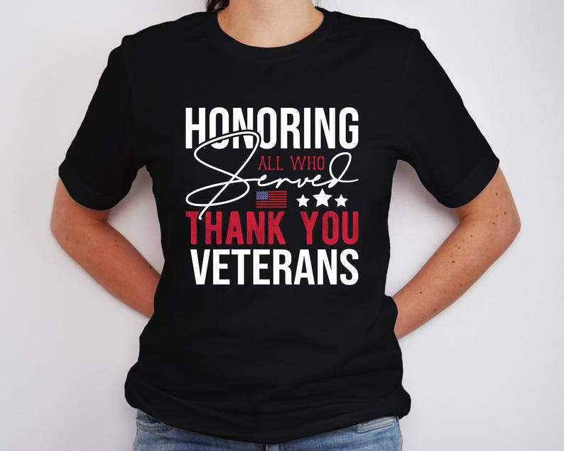 May include: Black t-shirt with white text that reads "Honoring All Who Served Thank You Veterans". The text is in a stylized font with a red, white, and blue American flag graphic.