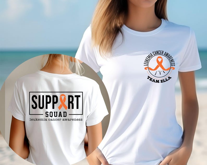 Puede incluir: Una camiseta blanca con un dise&ntilde;o de concienciaci&oacute;n sobre la leucemia. El pecho muestra una cinta naranja con el texto LEUKEMIA CANCER AWARENESS TEAM ELLA. La espalda presenta un gr&aacute;fico rectangular con SUPPORT SQUAD y leukemia cancer awareness.