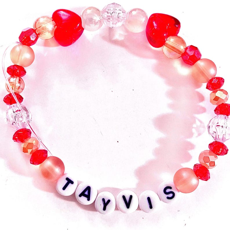 Handmade “tayvis” friendship bracelet inspired by Taylor Swift and Travis Kelce featuring red and gold beads, elastic stretch cord, and a romantic football-inspired aesthetic. Inspired by Chiefs game appearances, Eras Tour moments, and the excitement surrounding their relationship. Perfect for Swifties, football fans, concert outfits, friendship bracelet trading, bracelet stacks, gifts for best friends, and pop culture jewelry lovers.