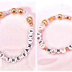 A bold gold beaded bracelet inspired by Taylor Swift’s provocative track “Father Figure” from The Life of a Showgirl. Featuring the phrase “I protect the family,” it embodies the song’s fierce, confident energy and power. The design echoes the lyric “My check’s bigger,” symbolizing strength, dominance, and independence. Perfect for Swifties who love Taylor’s fearless storytelling and unapologetic edge, this bracelet is a dazzling tribute to her boldest and most empowering Showgirl era.