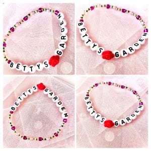 whimsical bracelet with a Taylor Swift vibe with its soft, pastel tones and delicate beads. "Betty's Garden" is spelled out in letter beads, accented by a pink rose, evoking a dreamy, romantic style perfect for those who love cottagecore aesthetics.