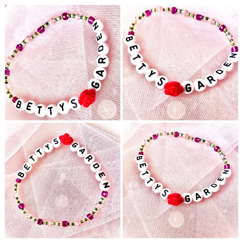 whimsical bracelet with a Taylor Swift vibe with its soft, pastel tones and delicate beads. "Betty's Garden" is spelled out in letter beads, accented by a pink rose, evoking a dreamy, romantic style perfect for those who love cottagecore aesthetics.