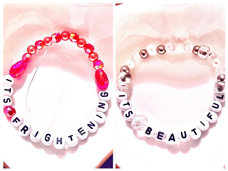 A collage featuring two handmade Taylor Swift The Life of a Showgirl variant-inspired friendship bracelets. One bracelet is bold red with letter beads spelling “it’s frightening”, reflecting the darker album edition. The other bracelet is shimmering silver with “it’s beautiful”, inspired by the lighter variant. Both stretchy beaded bracelets are perfect Swiftie jewelry, tour outfits, or collector gifts. Trendy Taylor Swift bracelet set for fans, stacking, and gifting