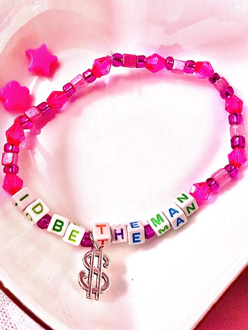Inspired by Taylor Swift's empowering anthem "The Man," features a dollar sign charm. For Swifties, this accessory symbolizes strength and independence, capturing the bold spirit of Lover era. Great costume for eras tour to match the man jackets