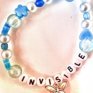 Celebrate the emotional depth of Taylor Swift’s debut album with this blue beaded bracelet, inspired by teardrops on My Guitar." Featuring a guitar charm, this bracelet is a perfect tribute to the song’s themes of heartbreak and unspoken love