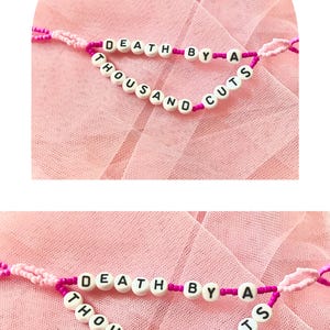 Beautiful intricate detailed bracelet featuring the song “Death by a thousand cuts,” which is about a devastating breakup. This would be a great comforting gift for a friend or loved one going through a breakup with their partner.