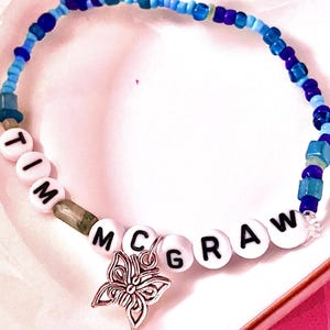 Celebrate the nostalgic magic of Taylor Swift's debut album with this beaded bracelet, inspired by "Tim McGraw" Featuring a delicate butterfly charm, this bracelet symbolizes transformation and timeless memories, making it a must-have for any Swiftie