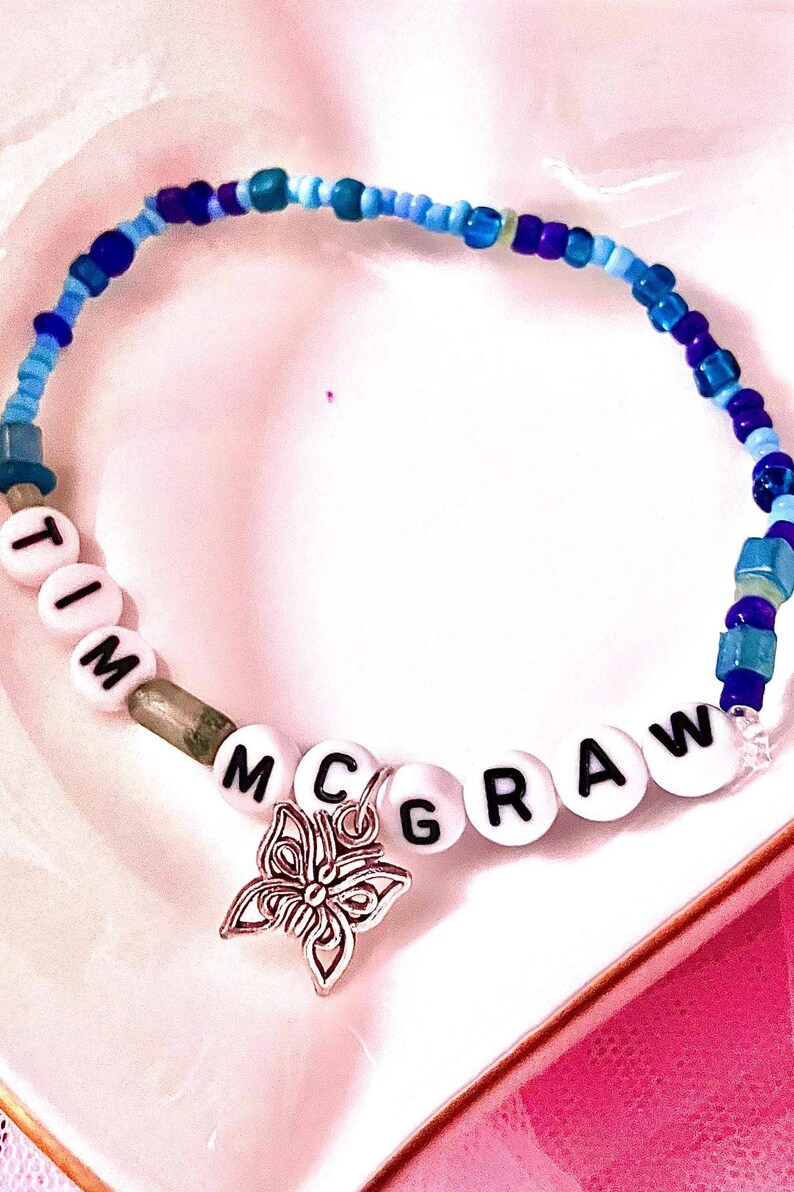 Celebrate the nostalgic magic of Taylor Swift's debut album with this beaded bracelet, inspired by "Tim McGraw" Featuring a delicate butterfly charm, this bracelet symbolizes transformation and timeless memories, making it a must-have for any Swiftie