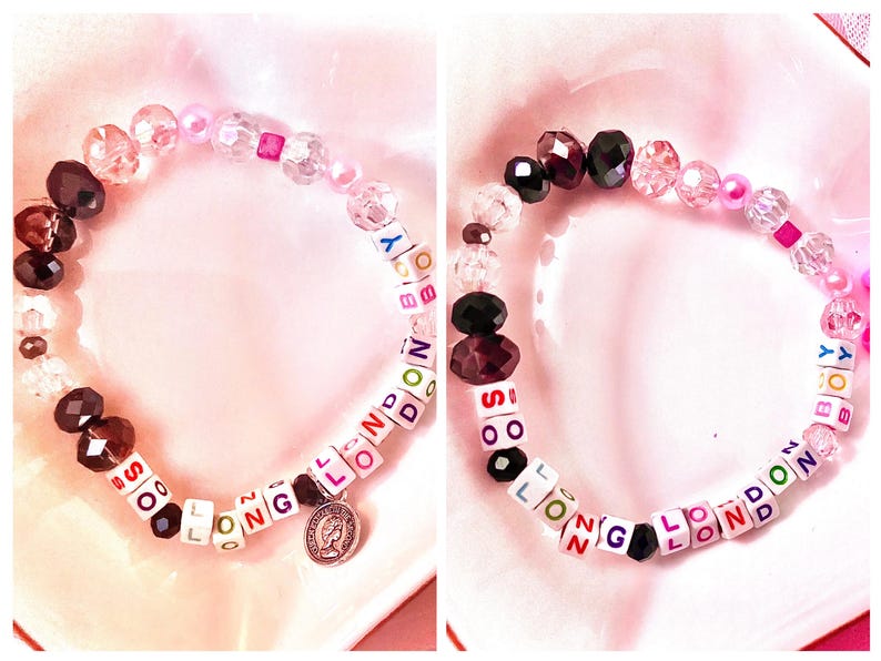 May include: Two bracelets with colourful letter beads spelling out "SO LONG LONDON" and "SO LONG LONDON" with a charm on one bracelet. The bracelets are made with clear, pink, and brown beads.