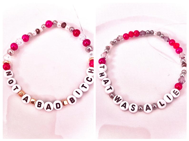 everyone’s so punk on the internet m The Life of a Showgirl: a red “Not a Bad Btch” and a gold “That Was a Lie.” Inspired by her track five, “Eldest Daughter,” the album’s most vulnerable song, these bracelets reflect the raw lyrics “I’m not a bad btch and this isn’t savage” and “When I said I don’t believe in marriage, that was a lie.” A heartfelt tribute to the song’s emotional honesty, perfect for Swifties who connect with Taylor’s introspective storytelling.