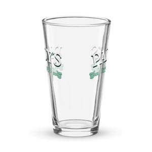 May include: A clear glass drinking glass with the text "Paddy's Pub" and "O'Malley's Pub" printed on the sides in green and white.