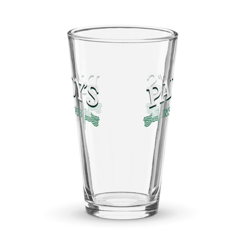 May include: A clear glass drinking glass with the text "Paddy's Pub" and "O'Malley's Pub" printed on the sides in green and white.