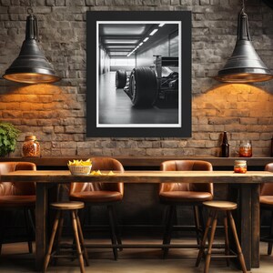 Detailed close-up of a Formula 1 racing car captured in black and white, featuring bold tire and chassis details. This art print is perfect for automotive enthusiasts and as sophisticated masculine decor for office or man cave. f1 wall art, f1 poster