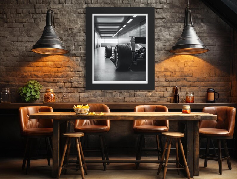 Detailed close-up of a Formula 1 racing car captured in black and white, featuring bold tire and chassis details. This art print is perfect for automotive enthusiasts and as sophisticated masculine decor for office or man cave. f1 wall art, f1 poster