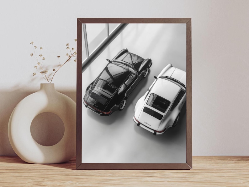 Classic Porsche 911 wall art featuring a stunning black and white duo. Perfect for man caves, offices, and garages, this minimalist print captures the essence of vintage sports cars, a must-have for auto enthusiasts and collectors.
