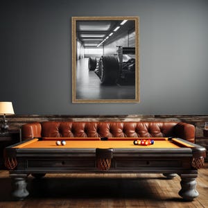 Stylish black and white Formula 1 race car print featuring detailed rear tire and wing designs in a modern garage setting. Ideal for adding masculine style to a man cave, home office, or garage decor with racing flair. f1 wall art, f1 poster