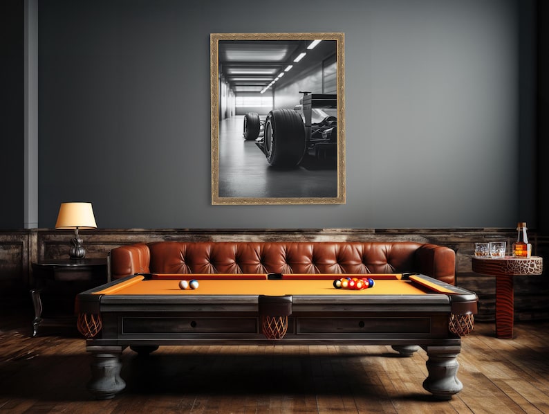 Stylish black and white Formula 1 race car print featuring detailed rear tire and wing designs in a modern garage setting. Ideal for adding masculine style to a man cave, home office, or garage decor with racing flair. f1 wall art, f1 poster