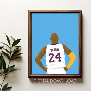 May include: Framed art print featuring a basketball player from the back, wearing a white jersey with the name "Bryant" and the number "24" in purple. The background is light blue, and the frame is brown. The words "DIGITAL DOWNLOAD" are at the bottom.