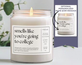 May include: A white candle with a black label that reads "smells like you're going to college". The label also includes the text "Infused with a splash of newfound freedom, a swirl of dorm room chaos, and a flicker of late-night study sessions."