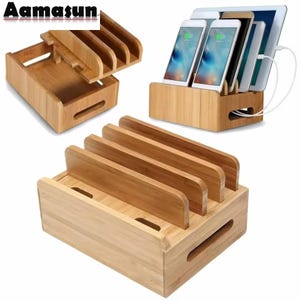 Può includere: Stazione di ricarica in bambù con più slot per smartphone e tablet. L'organizzatore in legno ha una base rettangolare con divisori verticali. Il design include uno slot per la gestione dei cavi. L'immagine mostra la stazione di ricarica con i dispositivi.