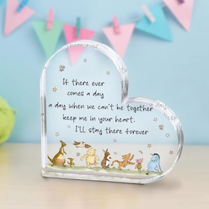 May include: A heart-shaped glass paperweight with a Winnie the Pooh quote: "If there ever comes a day a day when we can't be together keep me in your heart. I'll stay there forever." The paperweight features a scene of Winnie the Pooh and his friends walking together.