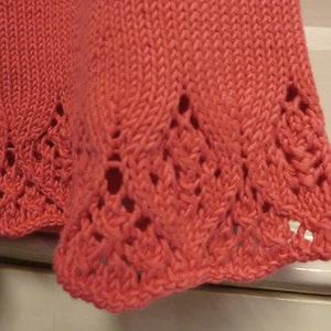 Hem of baby dress knitting pattern with lace