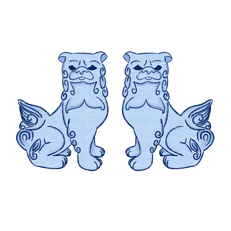 May include: Two blue ceramic foo dogs, traditional Chinese guardian lions, with intricate details and a stylized design. The foo dogs are facing each other, with their heads turned slightly to the side.