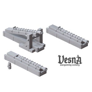 May include: A collection of gray miniature cannons, designed for wargaming scenery. The cannons are made of wood-like material and feature detailed barrel designs. The image includes the text "Vesna wargaming scenery".