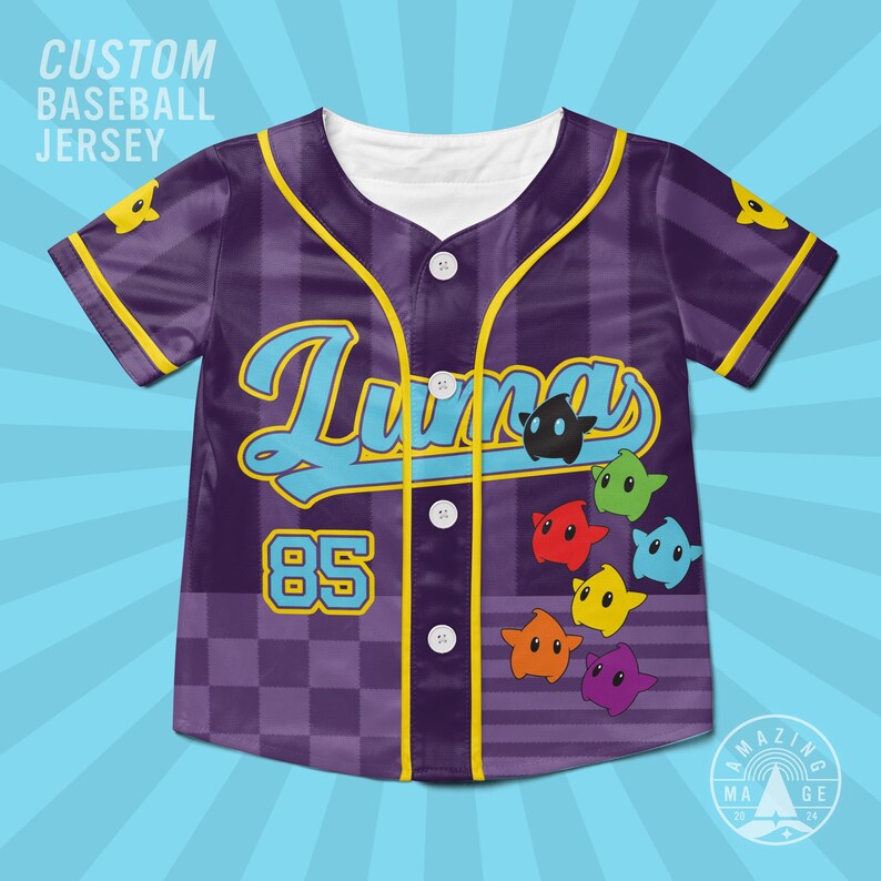May include: A purple baseball jersey with a checkered pattern, featuring the text "Luma" in blue, the number "85" in yellow, and colorful star-shaped characters. The shirt has a white collar, yellow trim, and four white buttons down the front.
