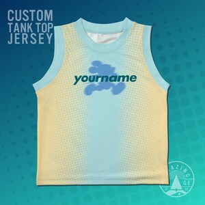 May include: Custom tank top jersey with a light blue and yellow gradient design. The jersey features the text "yourname" in green, with a blue cloud-like graphic above it. The top has a light blue collar and arm openings.