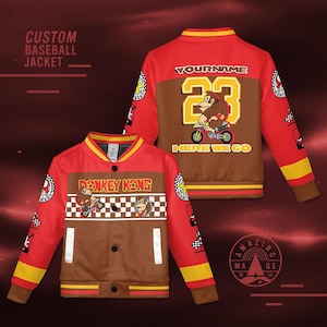 May include: Red and brown custom baseball jacket featuring Donkey Kong graphics. The jacket has a brown front panel and sleeves, with red accents and yellow stripes. The back of the jacket has a personalized name and the number 23.