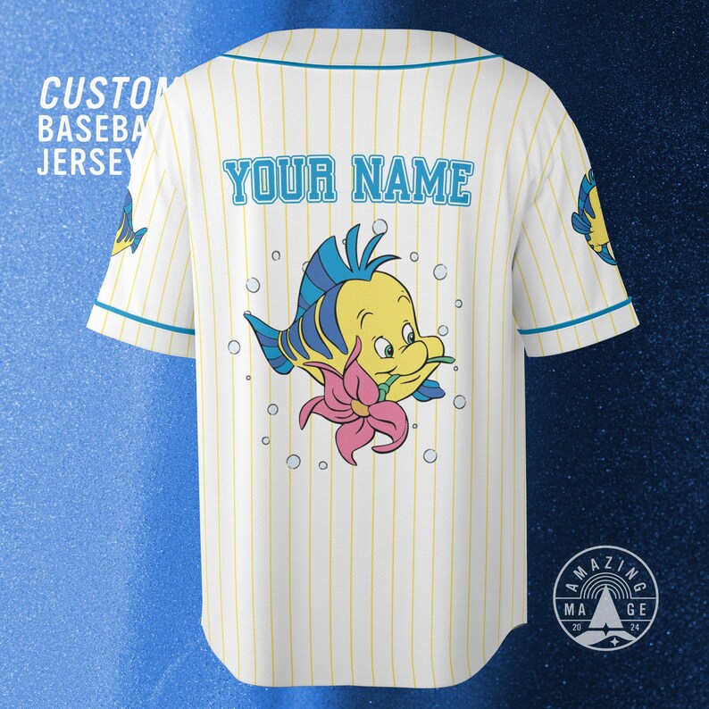 May include: Custom baseball jersey with a yellow and blue cartoon fish design on the back, surrounded by bubbles. The jersey is white with yellow vertical stripes and blue trim. The text "YOUR NAME" is above the fish.
