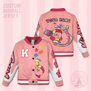 May include: Pink custom baseball jersey with white sleeves and red trim. The front features a large letter "K" and paint splatters. The back displays a cartoon character with the text "YOUR NAME".