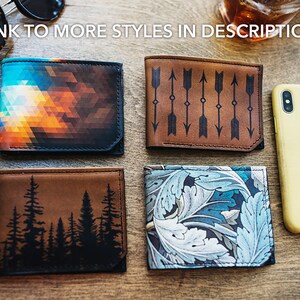 May include: Four leather wallets with unique designs are displayed on a wooden surface. One wallet features a geometric pattern in shades of orange, blue, and black. Another has an arrow design, and a third depicts a forest silhouette. The fourth wallet has a floral pattern.