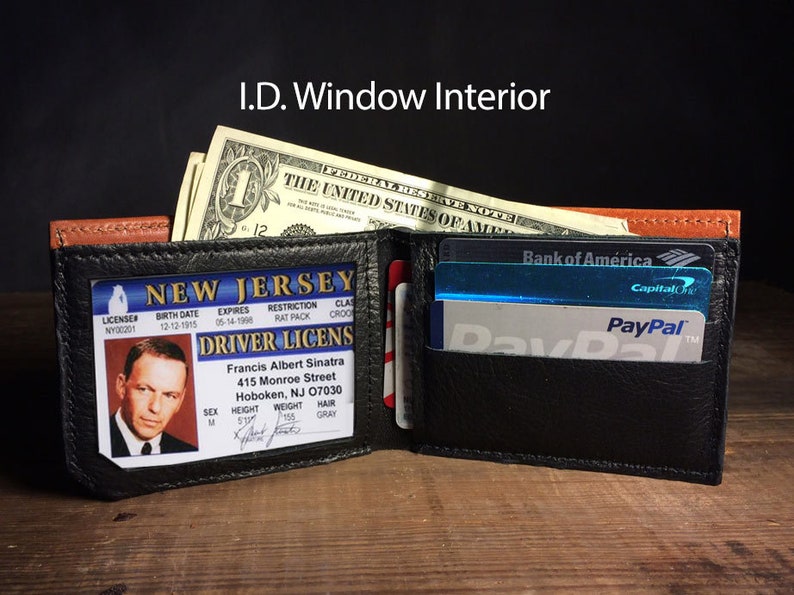 May include: Open black leather wallet with a brown accent, holding a New Jersey driver's license, cash, and credit cards. The license features a photo of Francis Albert Sinatra. The text "I.D. Window Interior" is at the top.