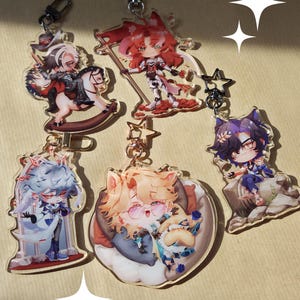 May include: A selection of acrylic character keyrings. The keyrings showcase vibrant illustrations of anime characters with intricate designs. Each keyring includes a metal clasp for attachment.