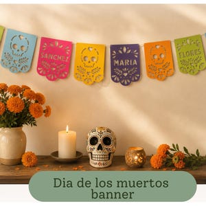 May include: A colourful paper banner featuring cut-out skull designs and personalised names including Olivia, Sanchez, Maria, and Flores. The banner is strung horizontally and displays various bright colours like lime green, blue, pink, yellow, and purple.