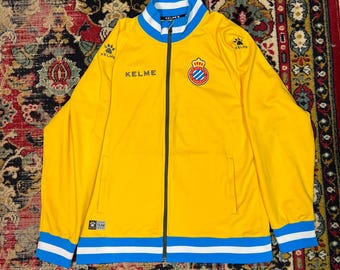Chaqueta deportiva Kelme RCD Espanyol amarilla y azul para fútbol, talla XL.