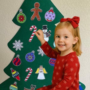 May include: A green felt Christmas tree with various decorative ornaments, including a star, gingerbread man, snowman, and candy canes. A young child in red pajamas with snowflake patterns is smiling and holding a candy cane.