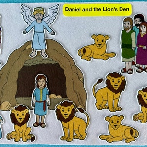 May include: A felt play set depicting the biblical story of Daniel and the Lion's Den. The set includes figures of Daniel, an angel, lions, and the king's men. The set also includes a brown felt cave with a large opening.