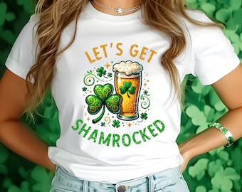 May include: White t-shirt with a green shamrock and a glass of beer. The text "Let's Get Shamrocked" is printed on the shirt.