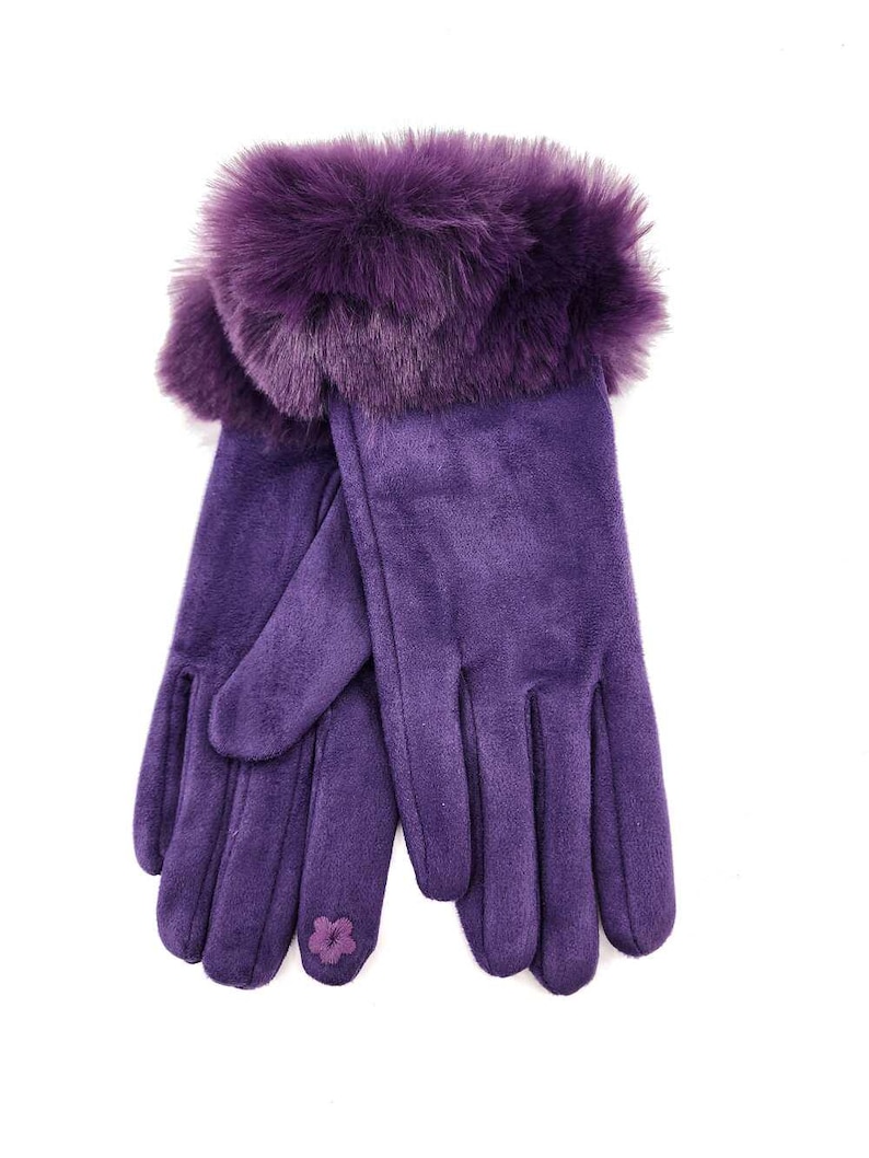 May include: Purple suede gloves with a faux fur cuff. The gloves have a small flower embroidered on the back of one glove.
